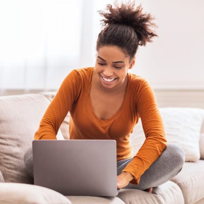 woman logging into patient portal from home.