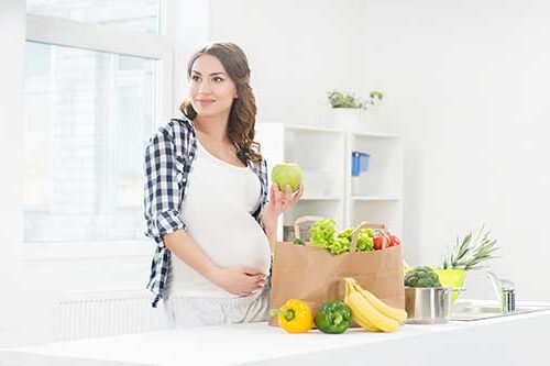 pregnant woman eating healthy foods.