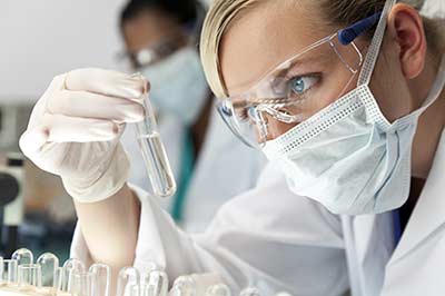 lab woman analyzing a sample.