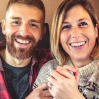 Couple sitting in an RV, smiling. Click to learn more about our tubal ligation clinical study.