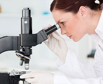 woman looking at microscope. 